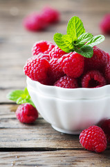 Sweet fresh raspberry and mint on the wooden table