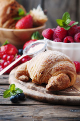 Fresh croissant with mix of berry