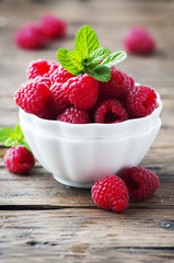 Sweet fresh raspberry and mint on the wooden table