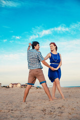  a young couple enjoys a mid summer late afternoon, on a wet san