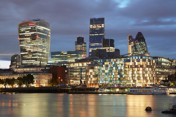 London skyscrapers skyline view illuminated in the evening with lights reflections