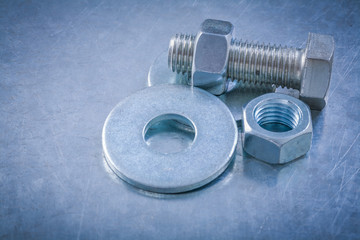 Steel bolt washers screwbolts screw-nuts on metallic background 