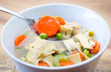 homemade chicken noodle soup in a white bowl