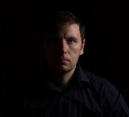 Dramatic portrait of a man in a low key. People