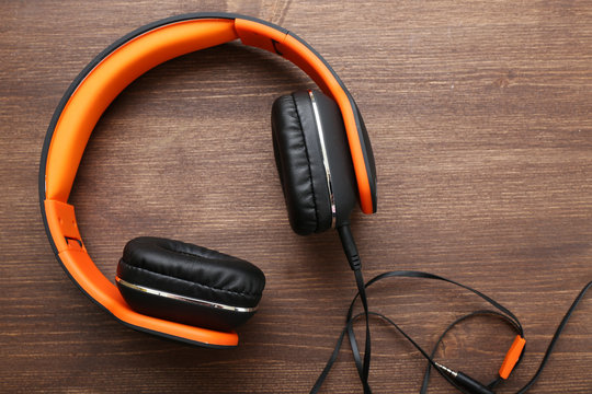 Headphones on wooden background