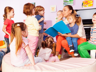 Teacher with kids read and discuss book