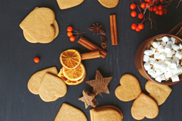 Heart shaped biscuits with marshmallow and sweet spaces on a table