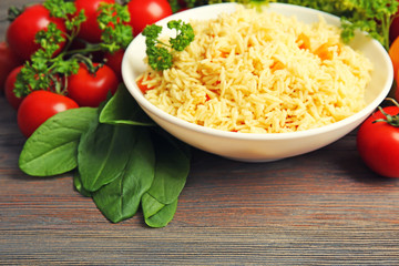 Dish of vegetarian rice on wooden table closeup