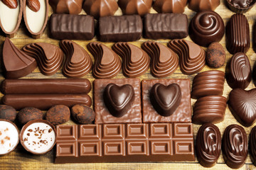 Assortment of delicious chocolate candies background, close up