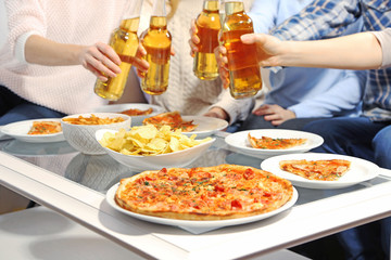 Friendly party with hot pizza and drinks, close up