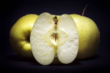 Golden delicious apples on black background