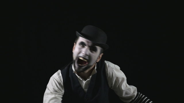 Young hilarious scary crazy evil mime making funny faces