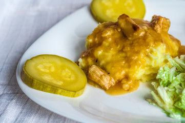 Mashed potatoes, gravy polytoe meat slices of fried meat. Salad of Chinese cabbage. Delicious lunch restaurant food. Dude looks sochno and delicious
