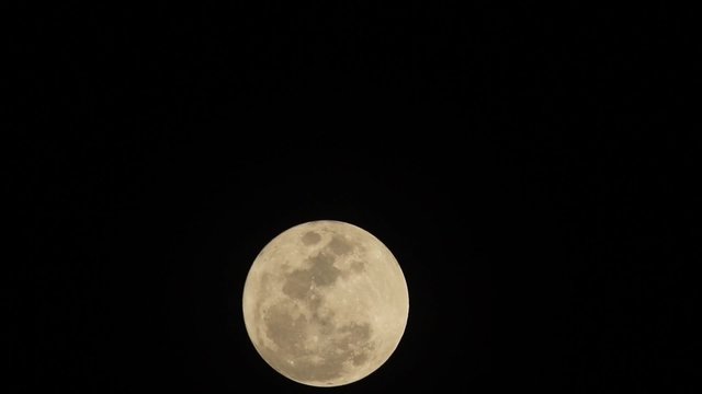 clear moonface of the full moon on black sky