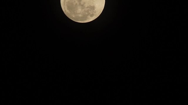 clear moonface of the full moon on black sky