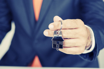 Hand with a house key 