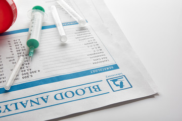 Fototapeta premium Blood test report with vials urine container and syringe elevate