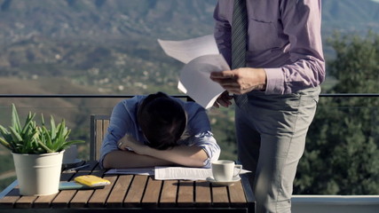 Young businesswoman getting rebuke from her boss on terrace in the country
