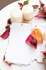 Two candles with paper tag on white table