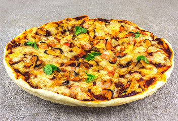 homemade pizza with seafood on linen tablecloths clouse- up