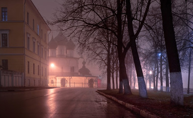 Ancient stone church in the center of the city at night in the fog. Yaroslavl, Russia