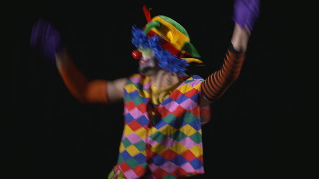 Young happy hilarious funny clown making funny faces