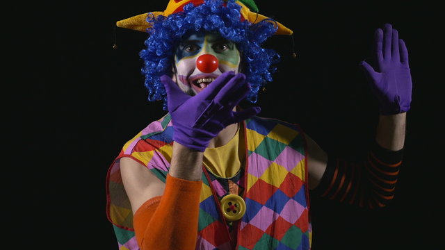 Young hilarious clown making funny faces