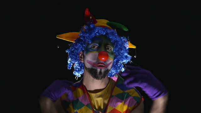 Young hilarious clown making funny faces