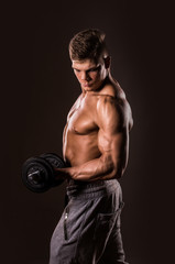 Fototapeta na wymiar muscular bodybuilder man holding weights