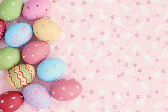 Vintage pastel easter eggs over flower patterned background