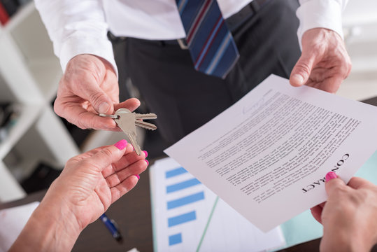 Realtor Giving House Keys To His Client