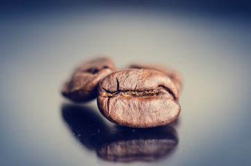 Coffee beans on a black background. Raw coffee beans. Grained product. Hot drink. Close up. Harvesting. Natural background. Energy