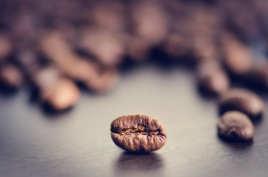 Coffee beans on a black background. Raw coffee beans. Grained product. Hot drink. Close up. Harvesting. Natural background. Energy