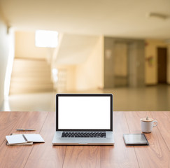 Laptop computer on wood table top with blur home interior