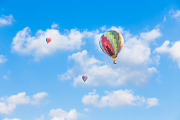 Colorful hot air balloon on blue sky background
