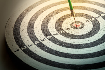 dart arrow hitting in the target center of dartboard,abstract of