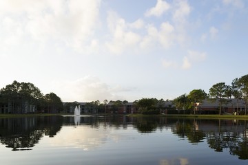 Lake in residential area with pine trees in Florida