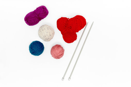 Balls of yarn with knitting needles