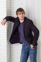 Young man leaning against the wall