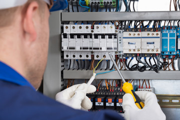 Male Technician Checking Fusebox