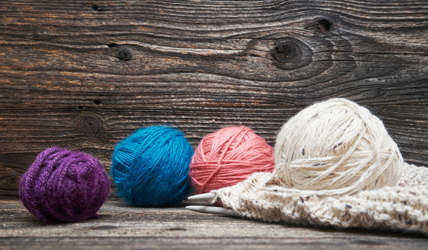 Balls of yarn with knitting needles