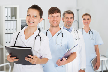 Confident Medical Staff Standing With Doctor