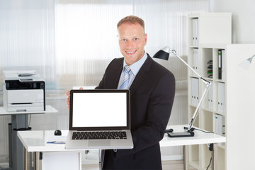 Businessman Showing Laptop With Blank Screen