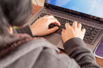 Woman using laptop at office desk