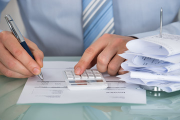 Businessman Calculating Invoice