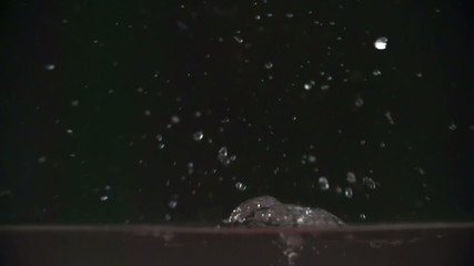 Ripe red bell pepper dropping into water in slow motion and floating against black background - Powered by Adobe