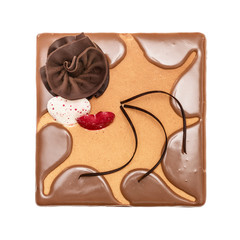 The square chocolate cream pie, cake decorated with red heart,  flower and glaze, the top view isolated on the white