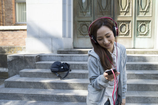 Women are listening to fun music with a headphone