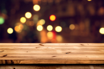 Fototapeta premium Empty wooden table for product placement or montage with focus to the table top, blurred bokeh background .