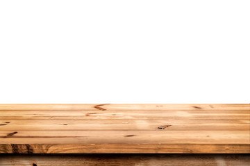 Empty wooden table for product placement or montage with focus to the table top in the foreground, with white background.